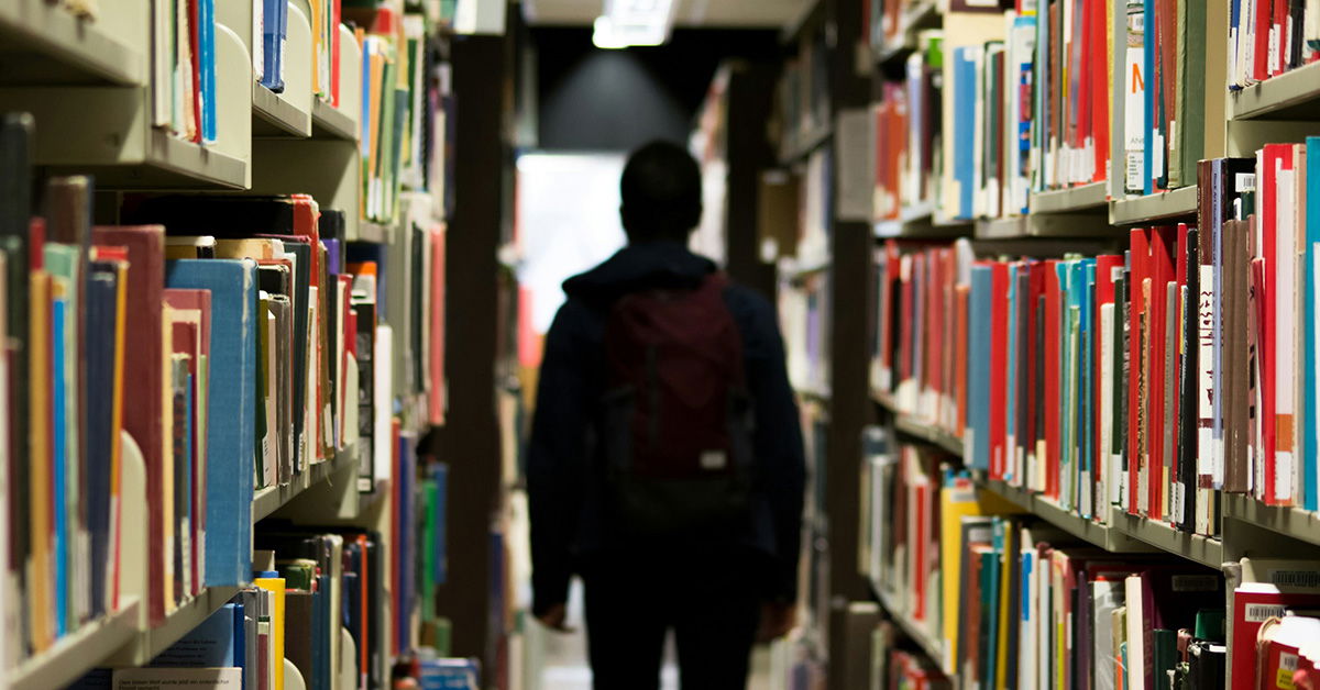 Child Walking Down Library Isle