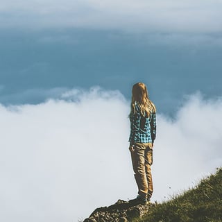 Woman Standing on Cliff
