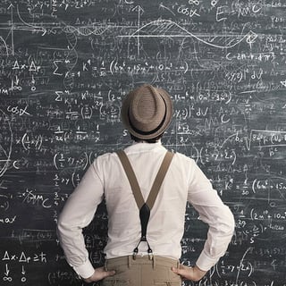 Man Looking at Chalkboard