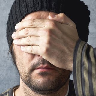 Man Covering His Eyes
